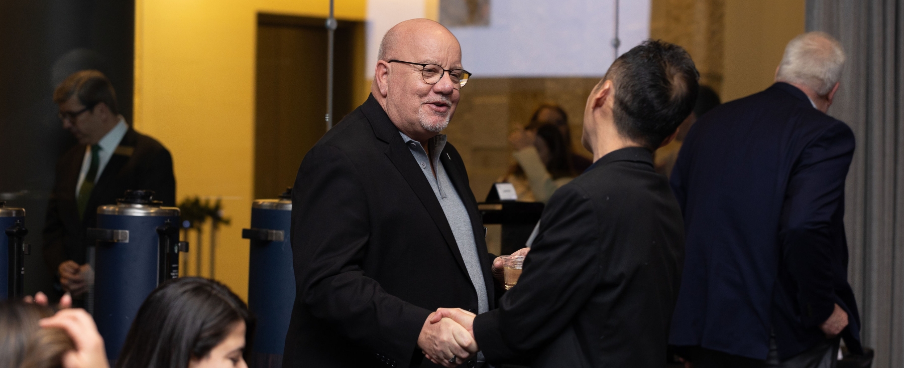 SCPS faculty member Dan Vonder Heide interacts with an SCPS student at the 2024 December Celebration. 